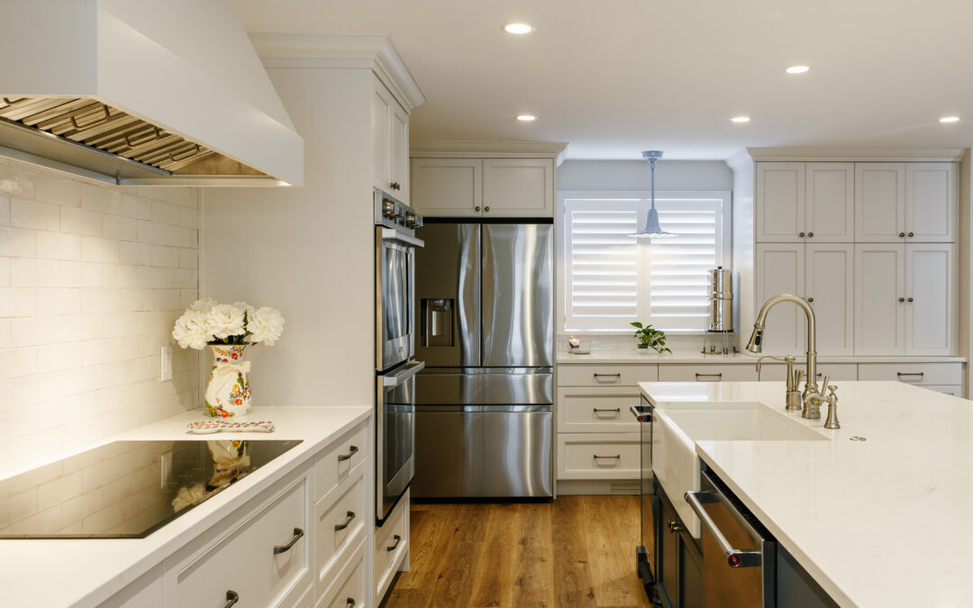 A new custom kitchen with white cabinets and light hardwood floors