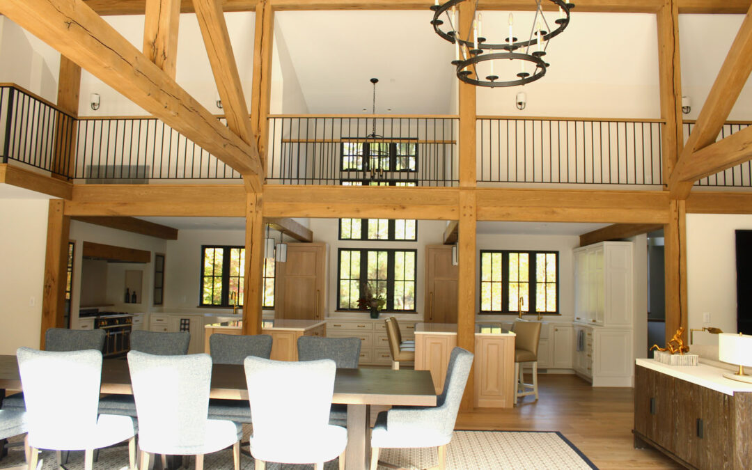 Great Room with exposed and finished ceiling beams and white furniture